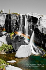 Selective color. Rainbow in waterfalls at Enchanged Pool